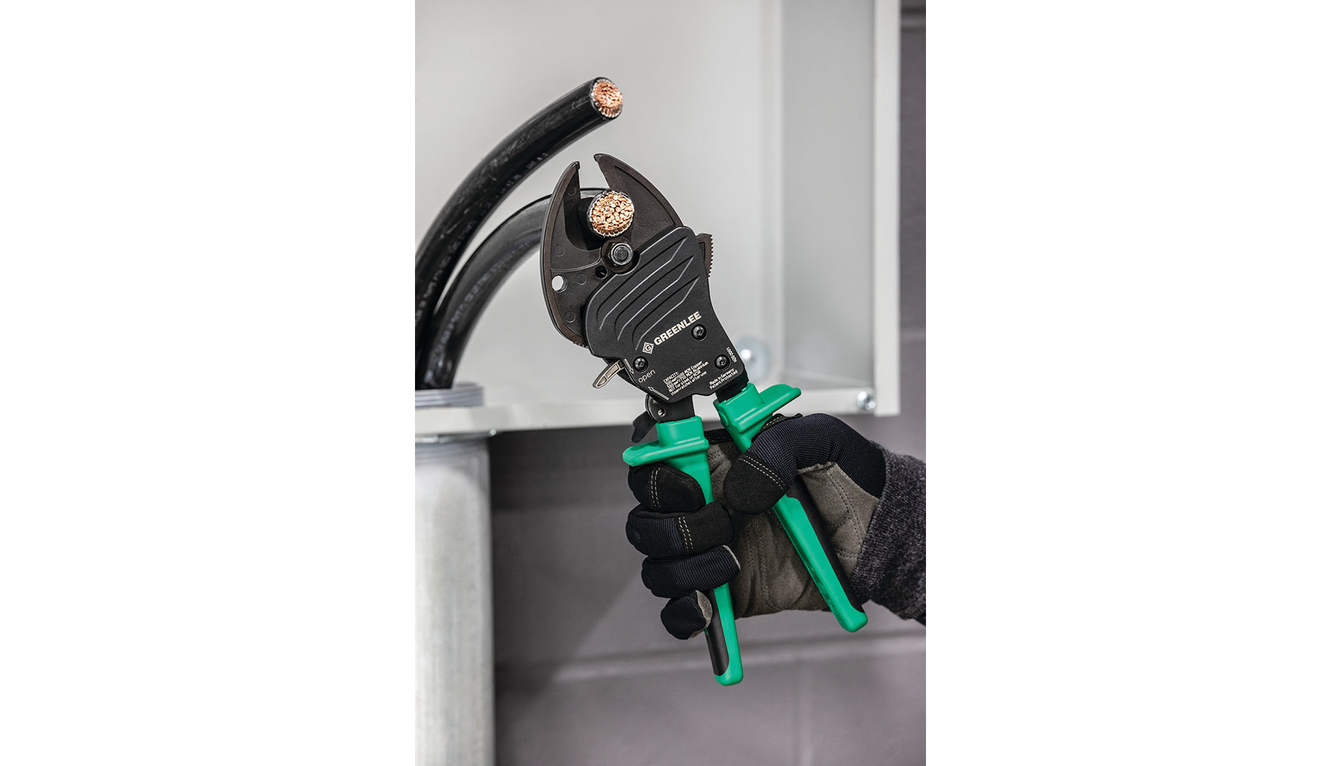 Black and green ratcheting cutter. Image by Greenlee.