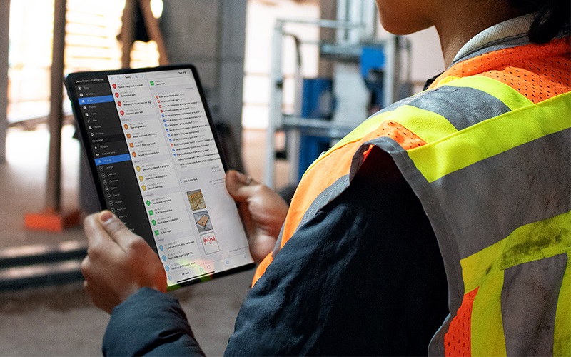 Contractor using Hilti Fieldwire software on a tablet