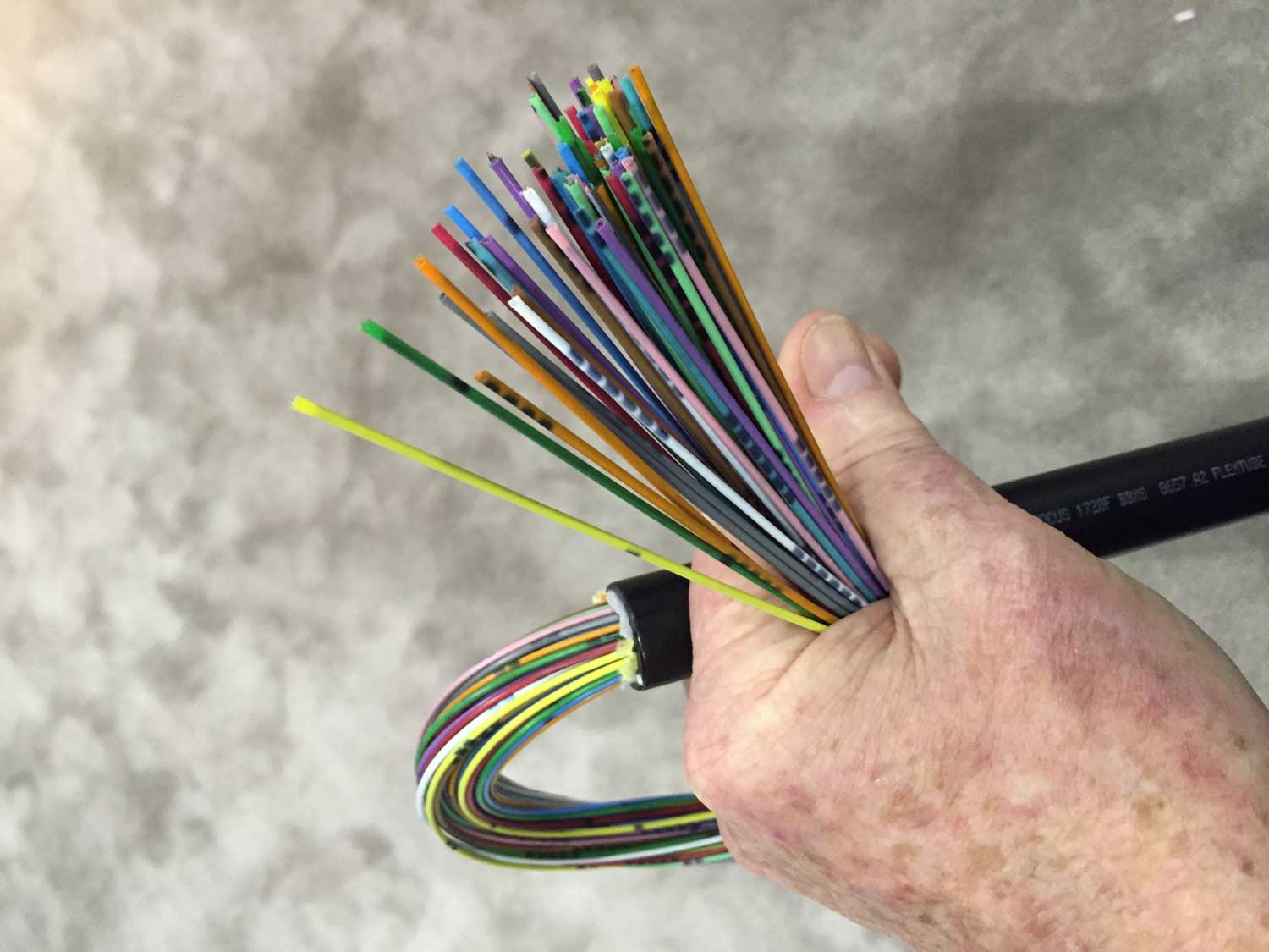 A 1,728-fiber cable with color-coded ribbons of fibers grouped for high-density splicing, following the TIA 598 standard to ensure efficient identification and management.