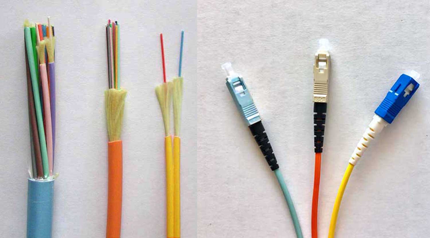 Various premises fiber optic cables and patchcords, with jacket colors such as aqua, orange and yellow, paired with connectors that follow color-coding standards for identification of fiber types like single-mode and multimode.