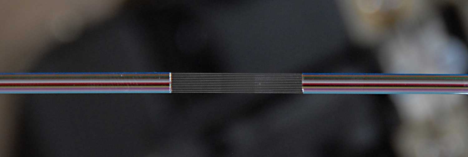 A ribbon splice showing 12 color-coded fibers joined in sequence, demonstrating proper application of the TIA 598 color codes for accurate splicing and identification.