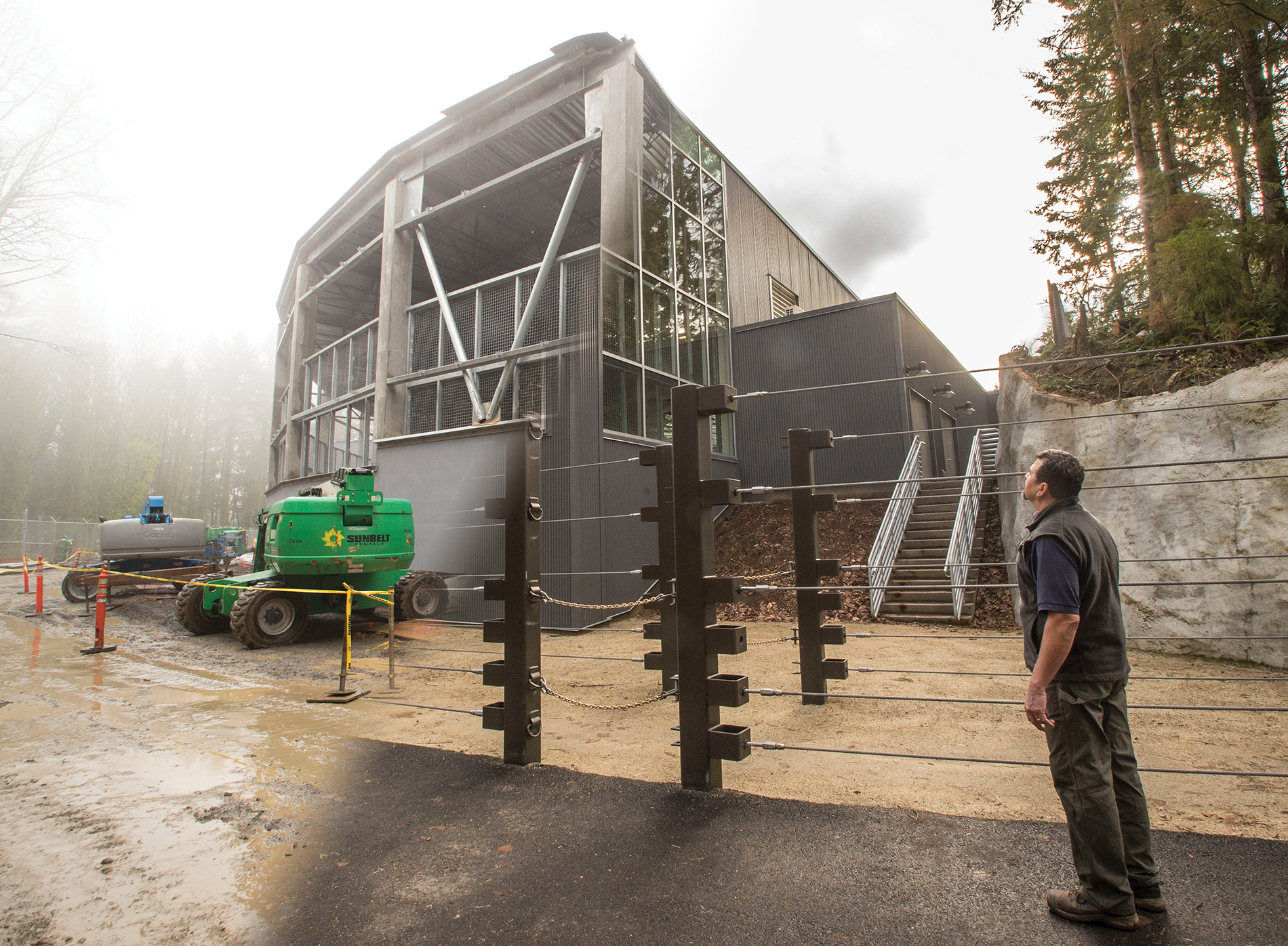 Keeper Gilbert Gomez checks out the exterior of Forest Hall from the Elephant Lands access road. Credit: Oregon Zoo / Michael Durham