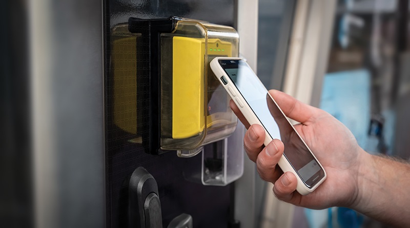 person using their phone as access card