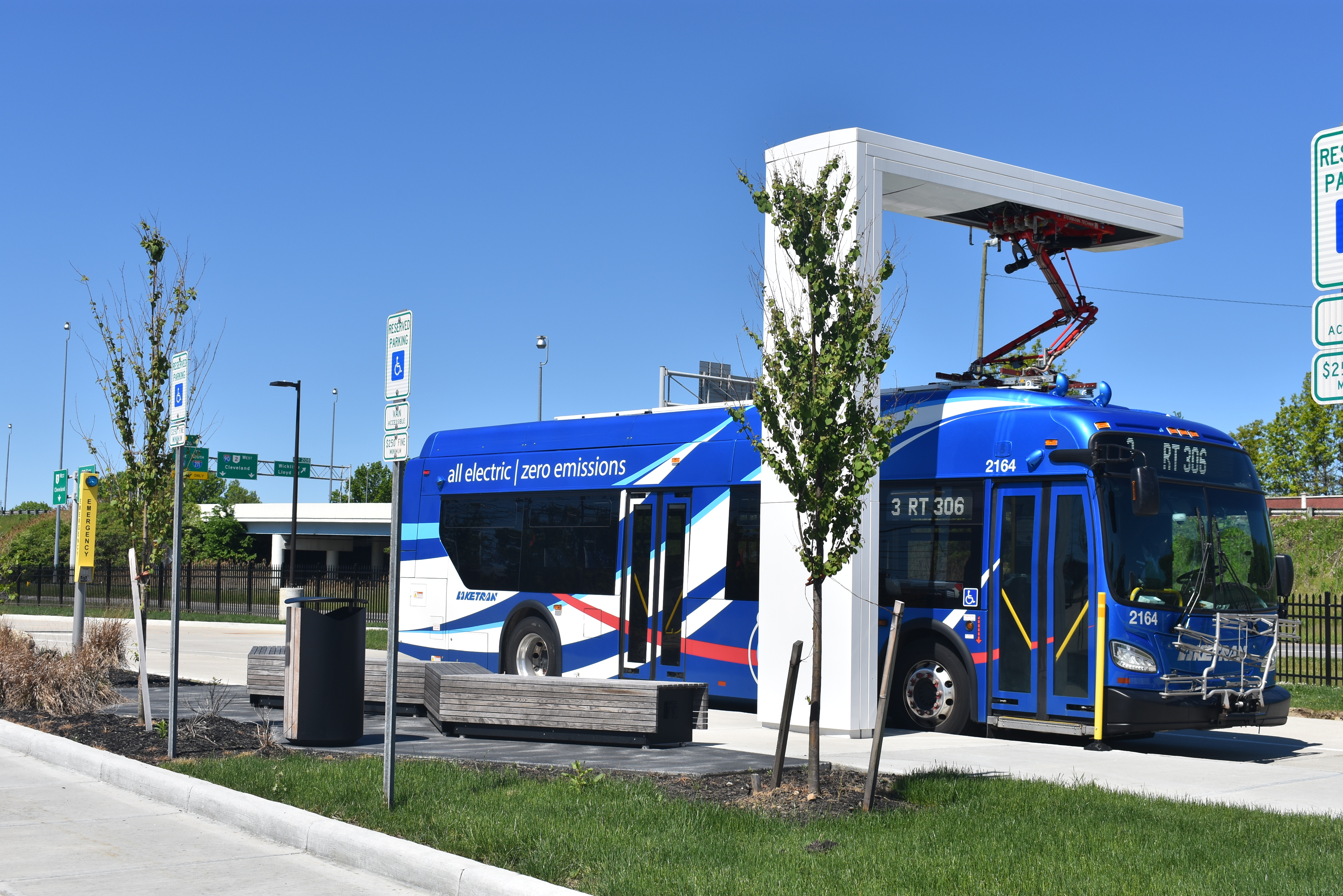 An electric bus attached to a charging station