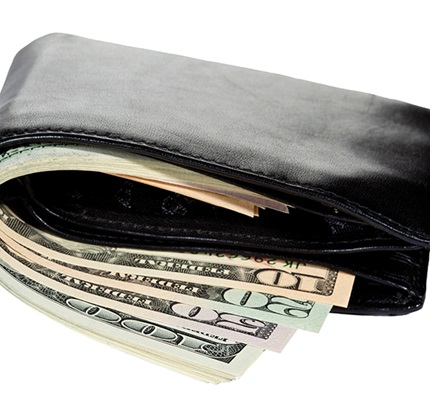 A wallet full of cash, illustrating the rebate and refund requirements that maybe involved in cost-plus contracts