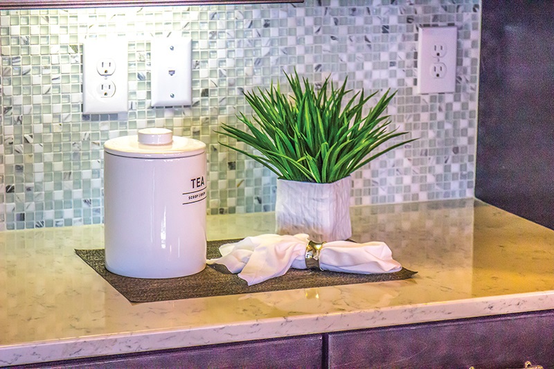 The general requirements for receptacles in wall spaces are found in NEC 210.52(A), and those for countertops or work surfaces are located in NEC 210.52(C).