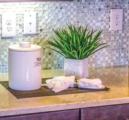 The general requirements for receptacles in wall spaces are found in NEC 210.52(A), and those for countertops or work surfaces are located in NEC 210.52(C).