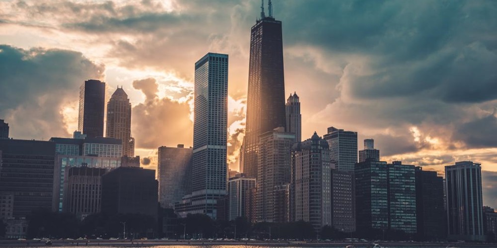 Chicago and Lake Michigan at sunset with storm clouds. Image by Max Bender / Unsplash.