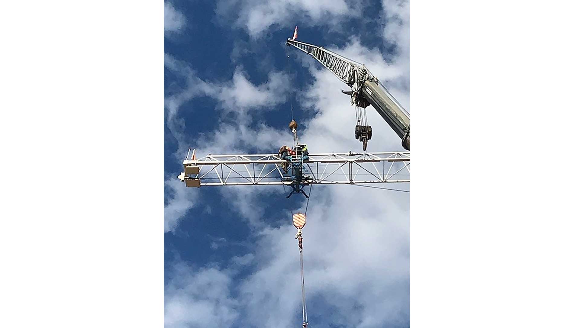 Tower crane against a blue sky. Image by Sturgeon Electric.