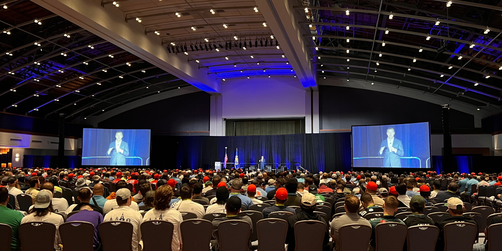 1,800 apprentices sit in a ballroom and watch keynote speaker Patrick J. Murphy.
