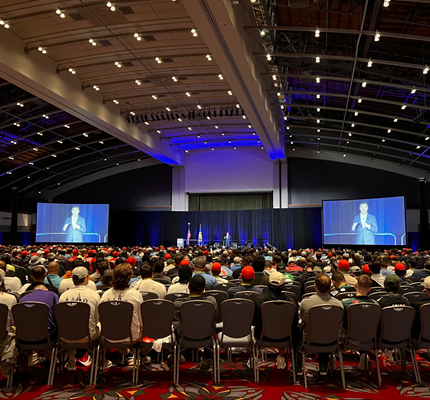 1,800 apprentices sit in a ballroom and watch keynote speaker Patrick J. Murphy.