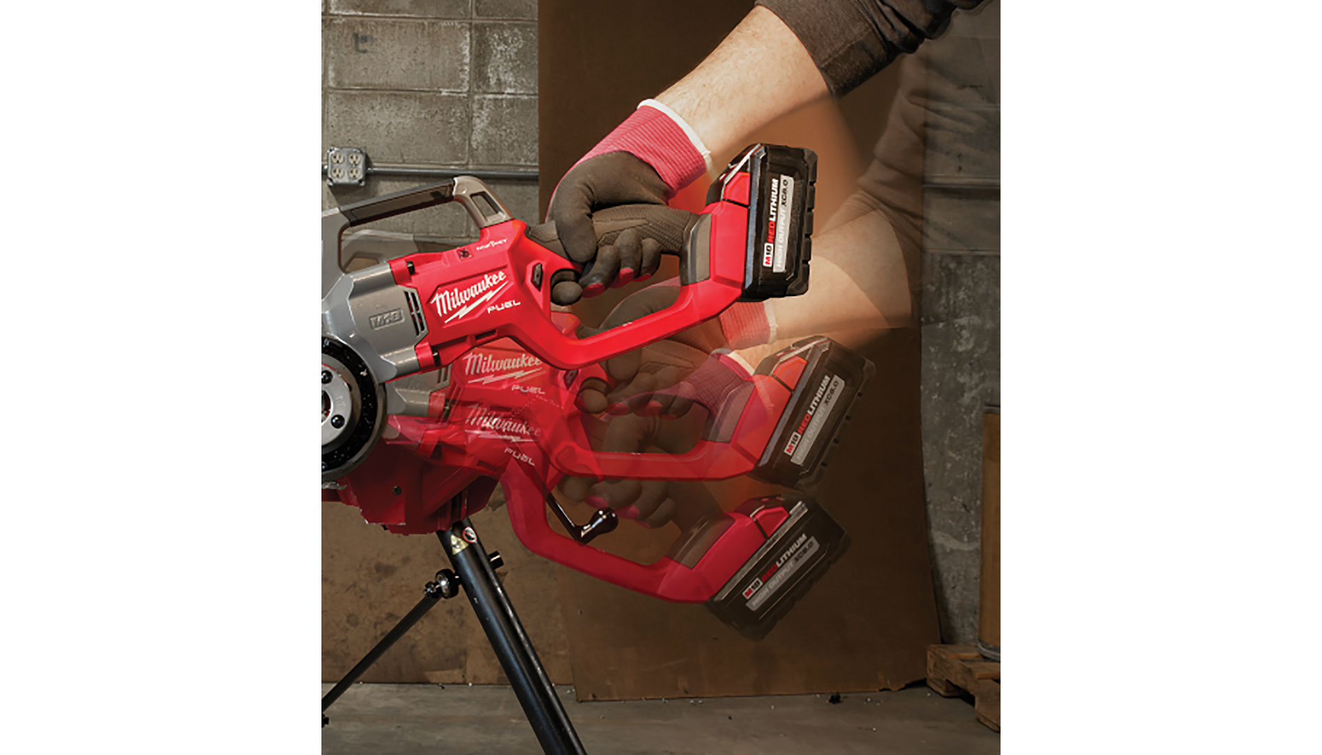 Timelapse of a gloved hand holding a red compact pipe threader. Image by Milwaukee Tool.