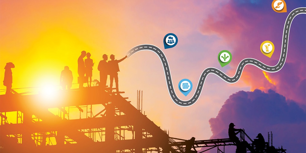 Illustration of workers silhouetted against a sunset. A road map leads past the clouds. Image by Shutterstock / Khvost / JU.STOCKER.
