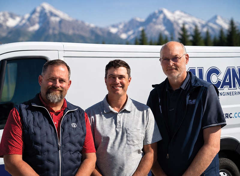 three men in front of a service man