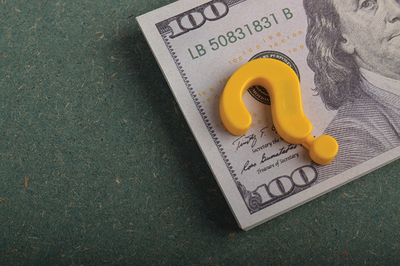 question mark in front of $100 bill