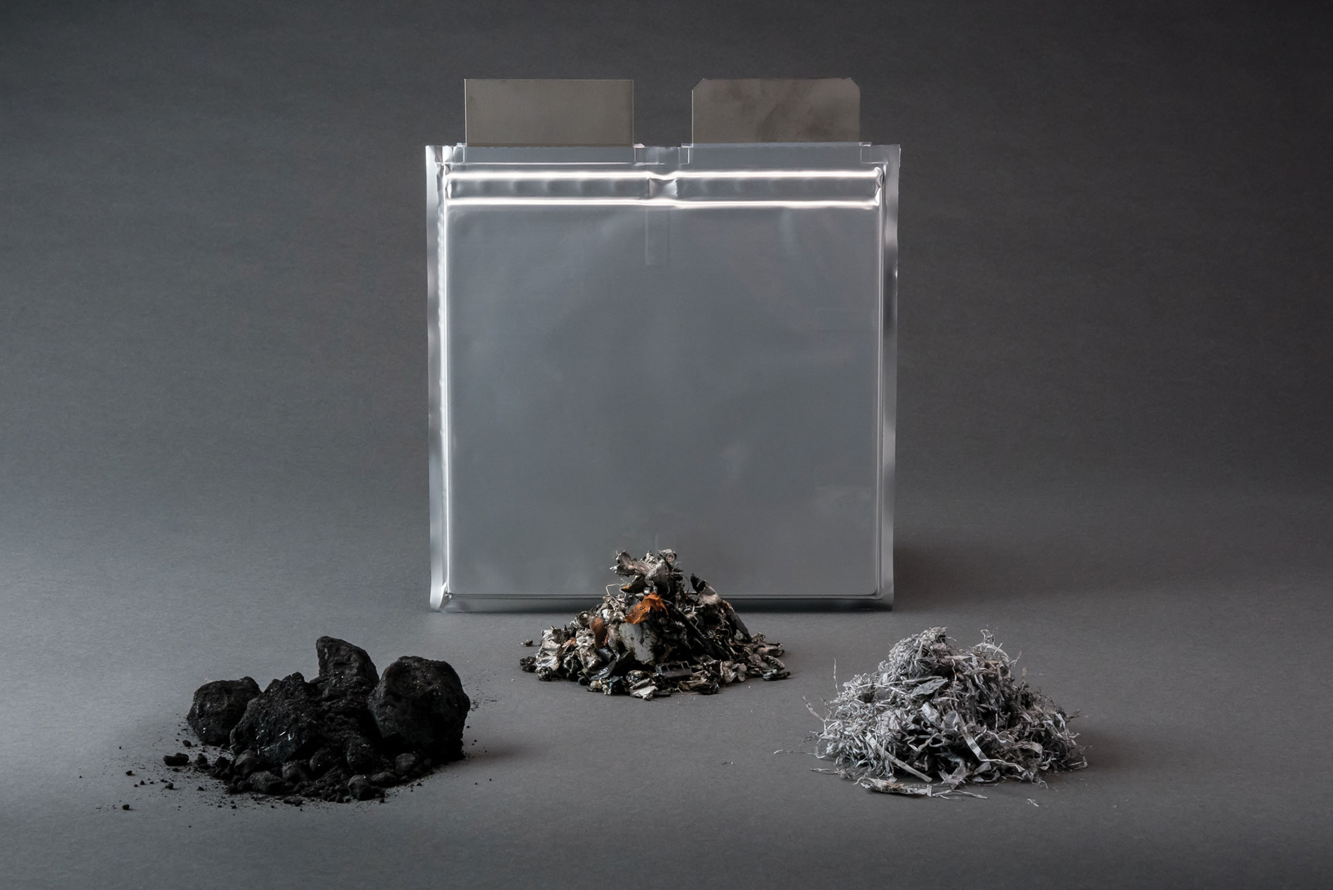 A metal box and shredded battery materials. Image by Argonne National Laboratory.