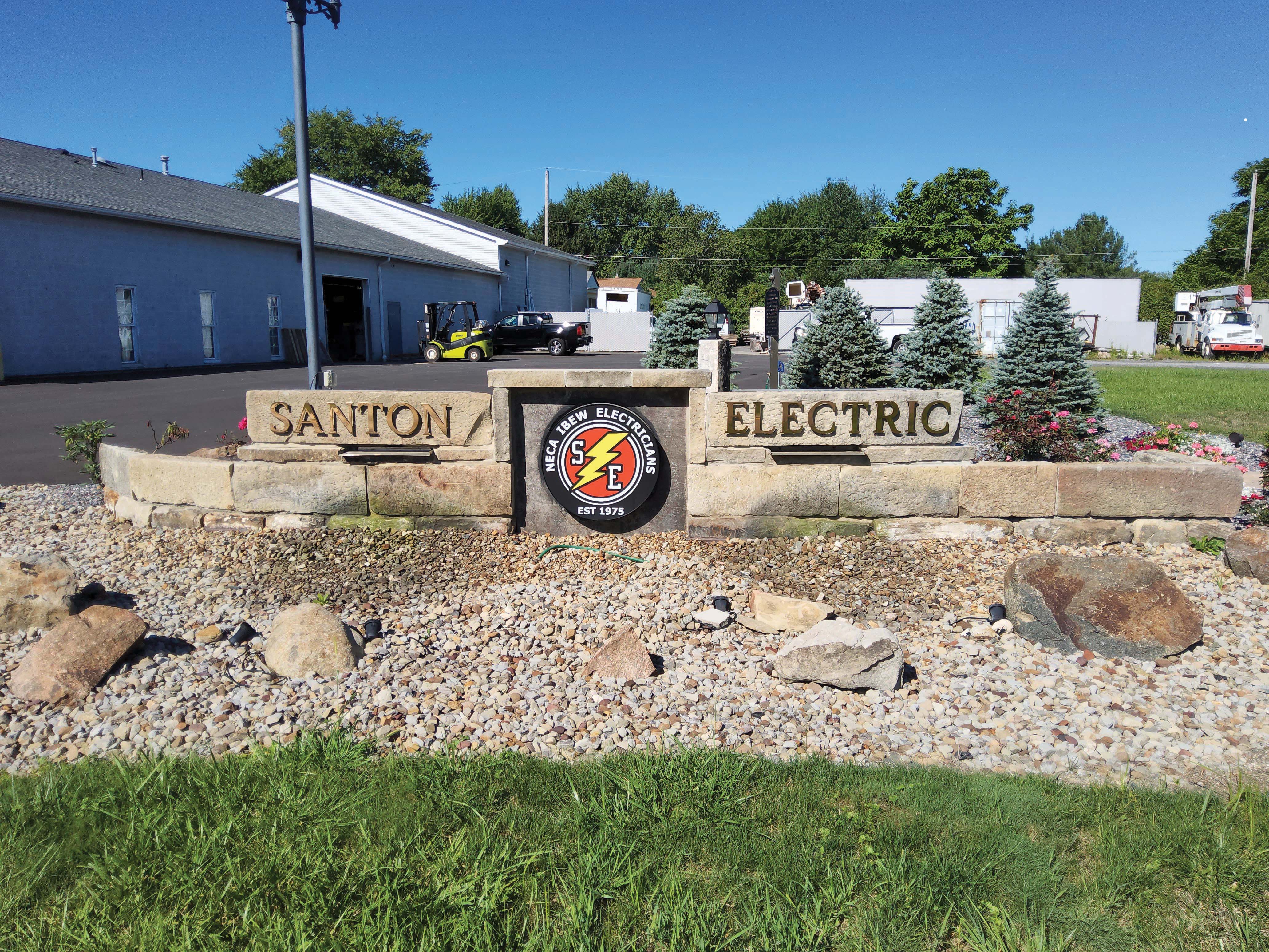 Stone wall with a Santon Electric sign. Image by Santon Electric Co. Inc.
