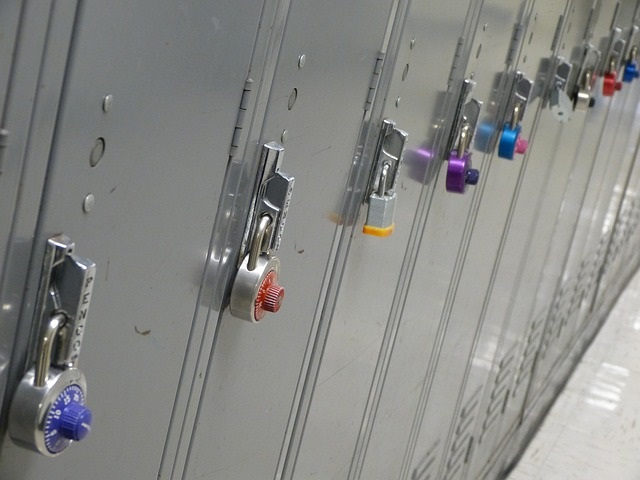 A row of gray school lockers with padlocks