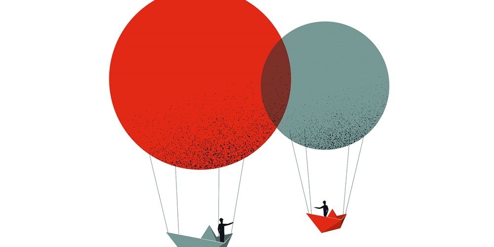 Illustration of two people floating in two paper boat hot air balloons. Image by Shutterstock / MJgraphics.