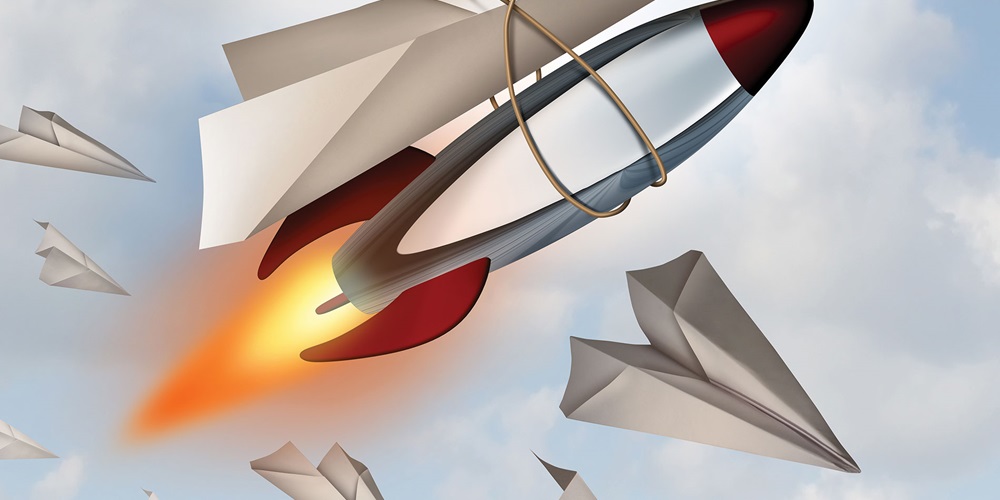 Illustration of a paper plane tied to a rocket against a cloudy sky. Image by Shutterstock / Lightspring.