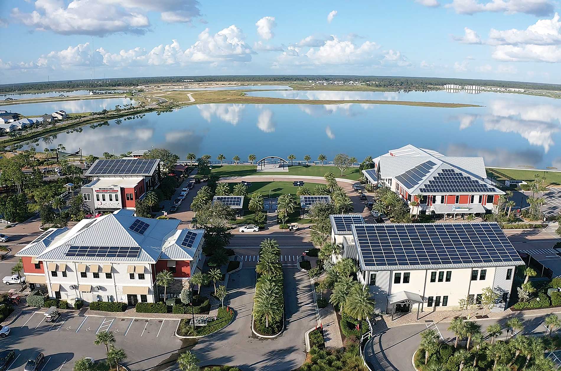 Commercial buildings with solar paneling next to a body of water. Image by Florida Power & Light Co. and Babcock Ranch.