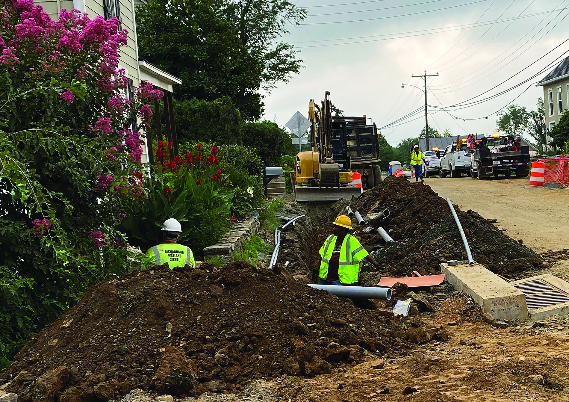 Workers in a trench outside a home and garden. Image by Town of Hillsboro.