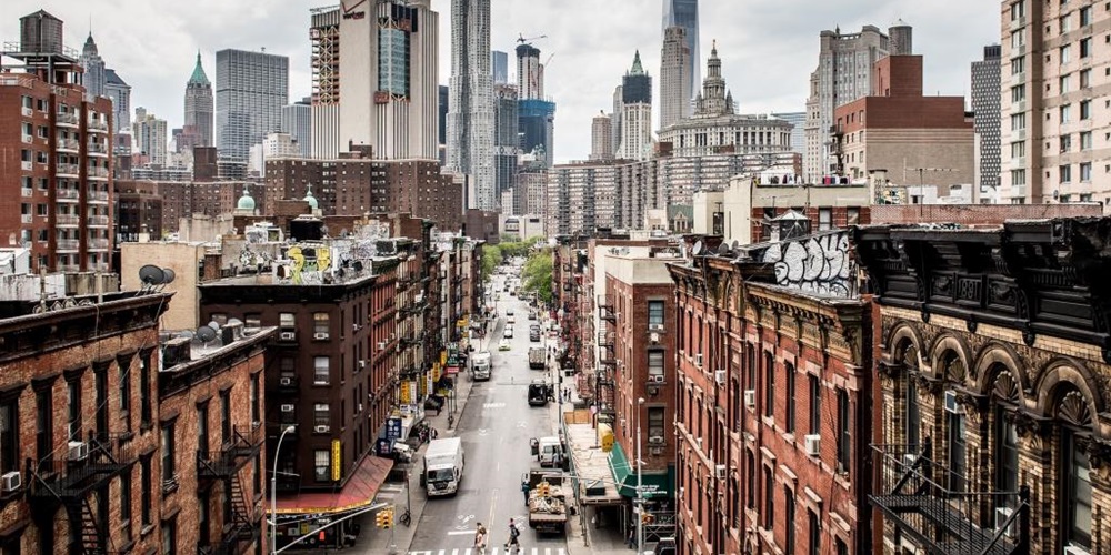 Chinatown in New York, with Manhattan skyscrapers in the background. Image by FilippoBacci / iStock.