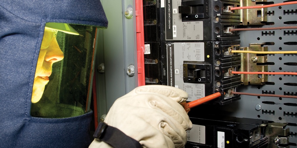 Electrician in an arc flash suit