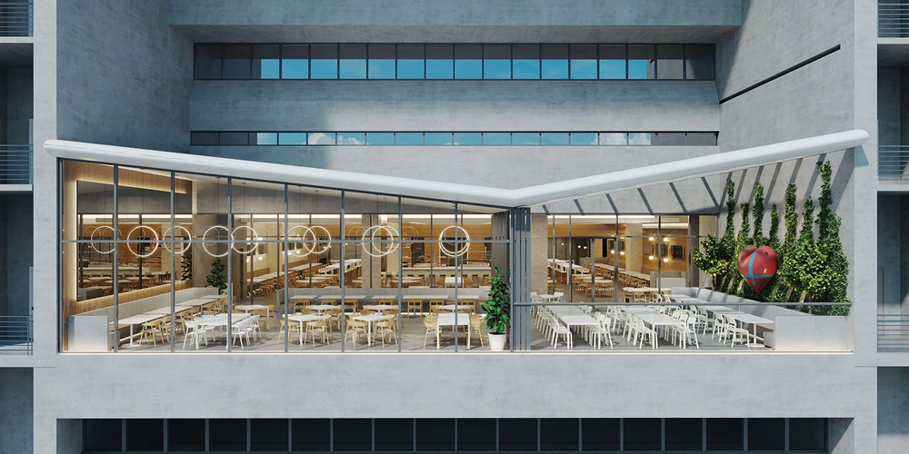 Warmly lit cafe with greenery, photographed from the outside. Image by Gordana Jordanovska.
