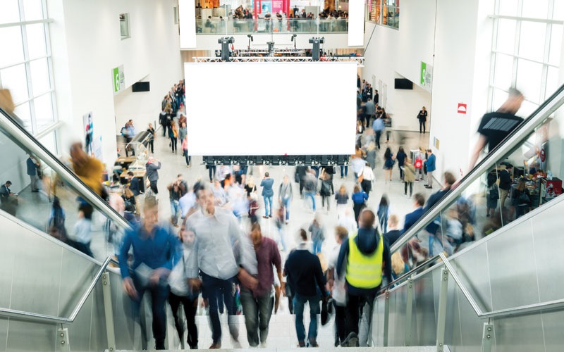 Blurred shot down the stairs of a busy convention center