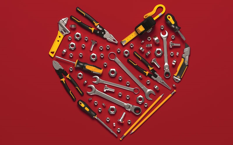 A heart made out of tools on a dark red background