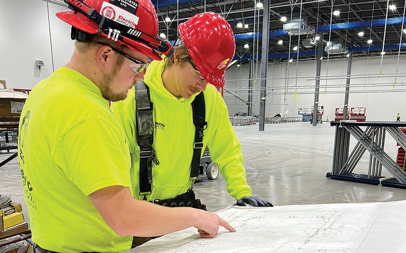 Electric Supply Co. Inc. foreman Caleb Chedester, left, instructs Jaylen Kemp, a third-year apprentice.