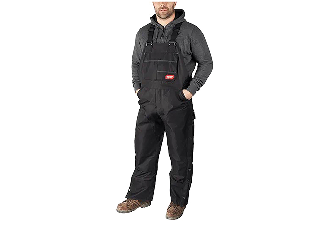 A man wears black overalls. Image by Milwaukee Tools.