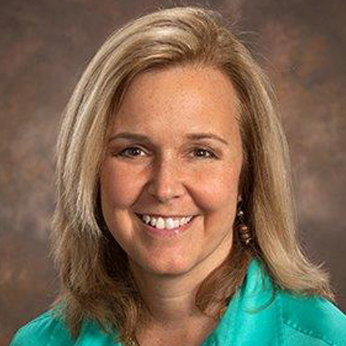 Missy Henriksen - a woman with blonde hair and brown eyes smiles at the camera.